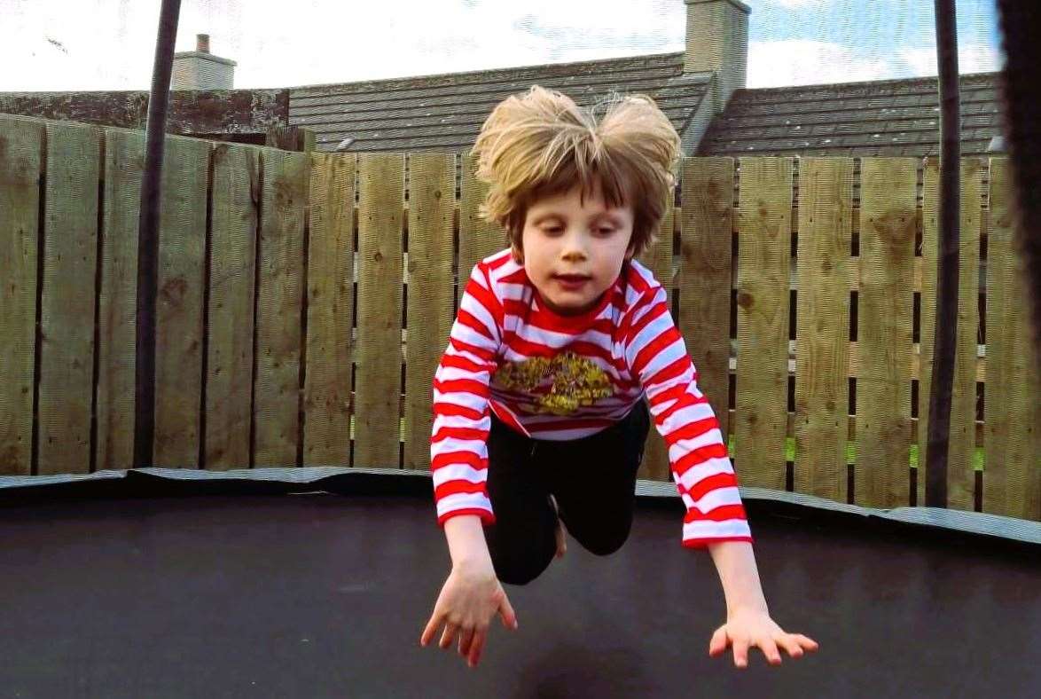 Ollie playing on a trampoline. He is non-verbal and diagnosed as severely autistic.