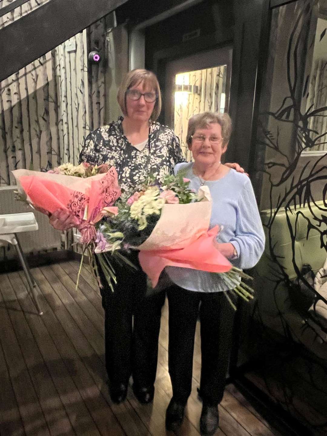 Joyce Reid (right) and Maureen Webster were presented with flowers on their retiral from Reids Bakery.