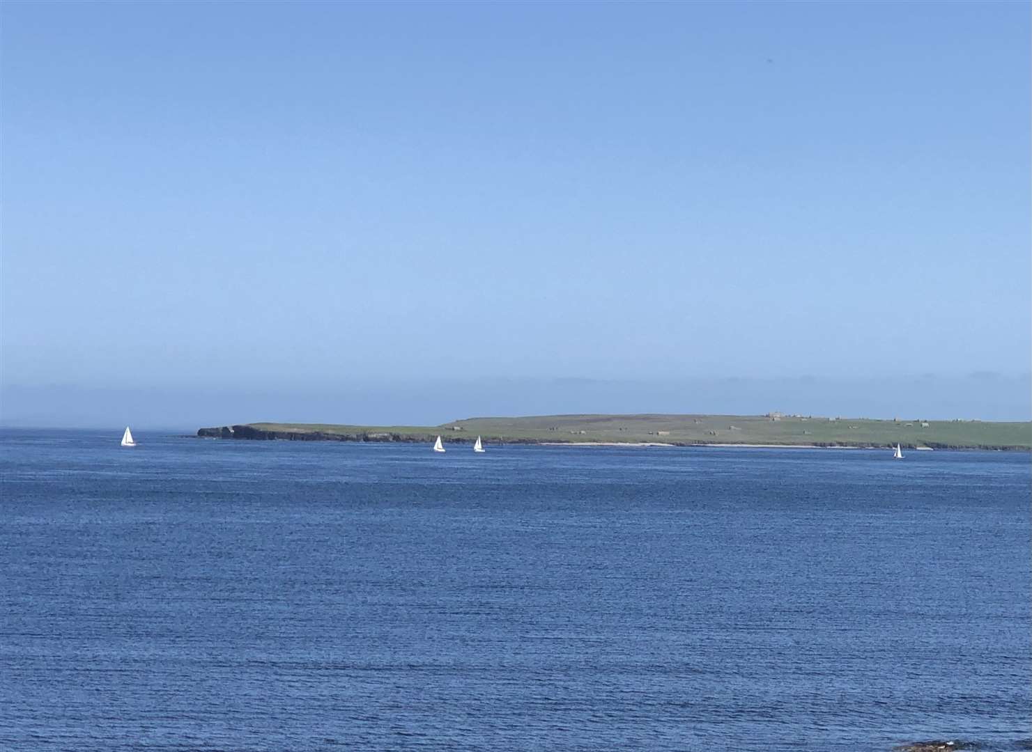Lyall Rennie took this photograph of a flotilla of yachts passing through the Pentland Firth with Stroma in the background. 'Totally blue skies and sea, a rare thing in Caithness,' he said!