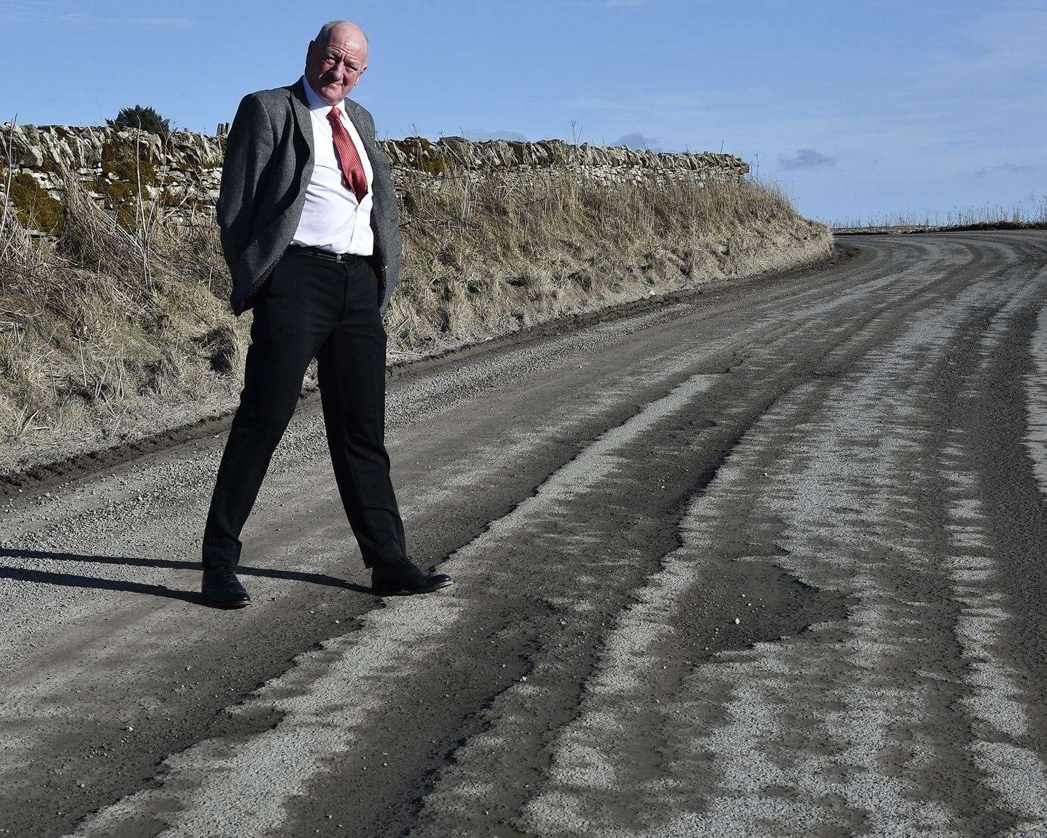Iain Gregory of Caithness Roads Recovery on a potholed section of the B870. He asked: 'Is this county getting a fair deal?' Picture: Mel Roger
