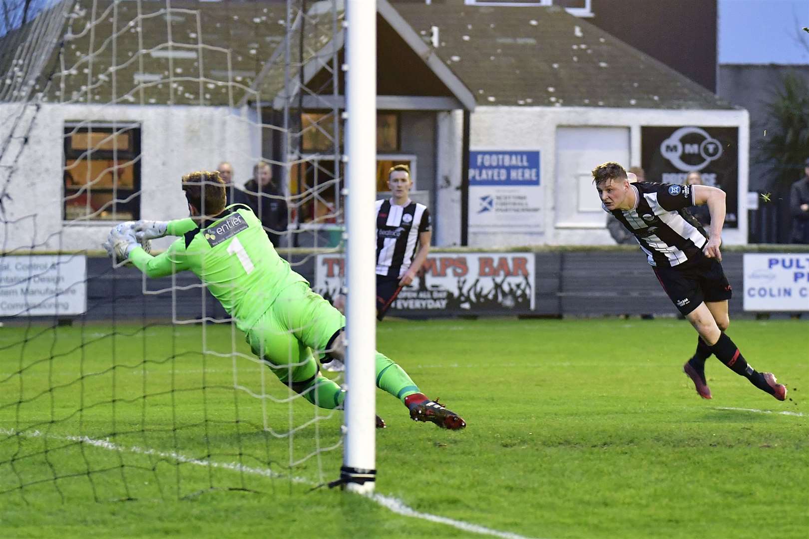 Fraserburgh keeper Paul Leask dives to his left to save a header from Wick Academy's Kuba Koziol. Picture: Mel Roger