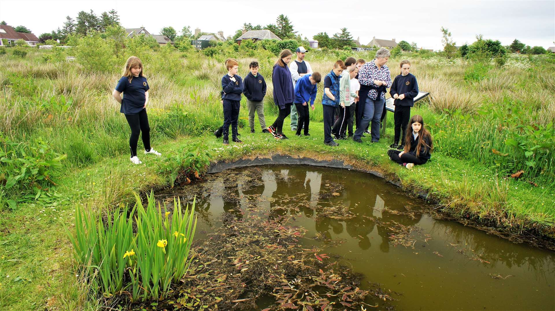The children gather by a pond and learn about plants and animals that live in and around it. Picture: DGS
