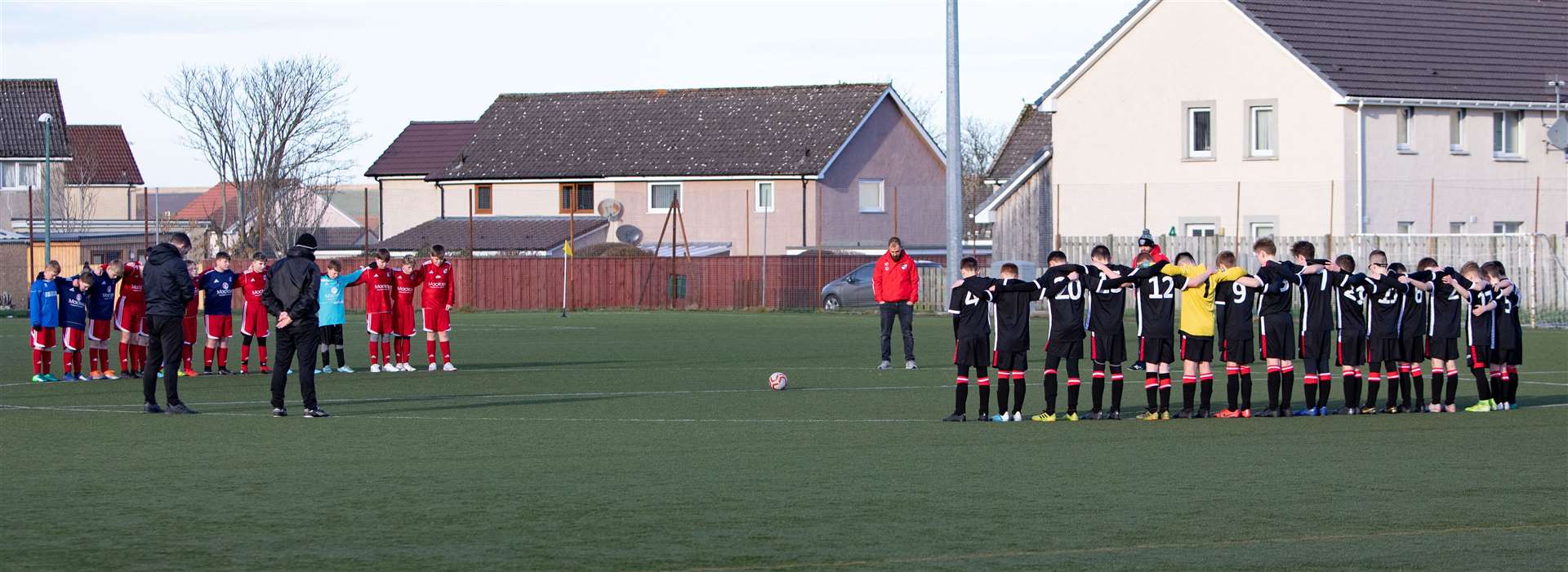 The two squads observing a minute's silence prior to kick-off in Thurso on Remembrance Sunday. Picture: Gareth Watkins