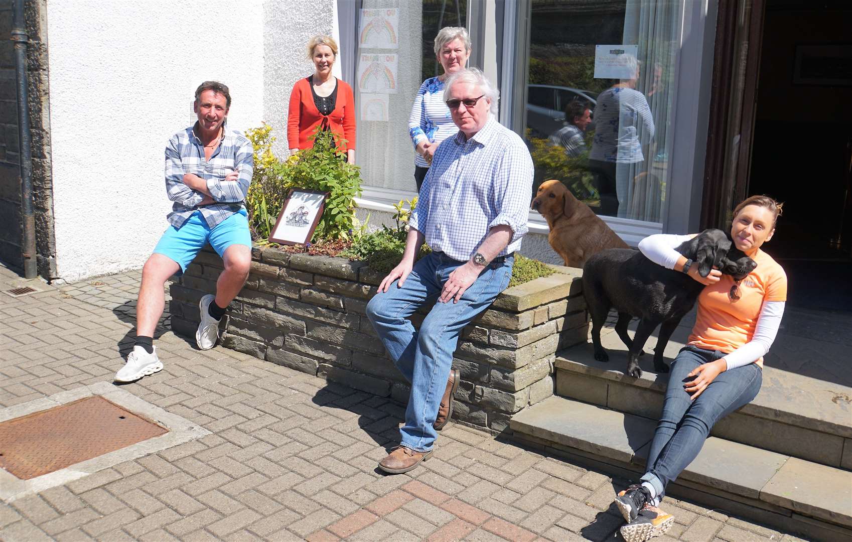 Scott, left, was greeted by the owners of Mackays Hotel in Wick after walking all the way from Scrabster. Picture: DGS