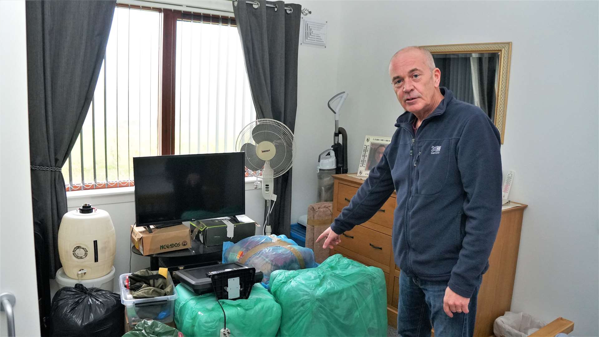 Bob Wright has taken the council to task over a dampness issue in his supported house at Lybster. He showed how he has to wrap many of his items in plastic to keep the damp smell away. Picture: DGS