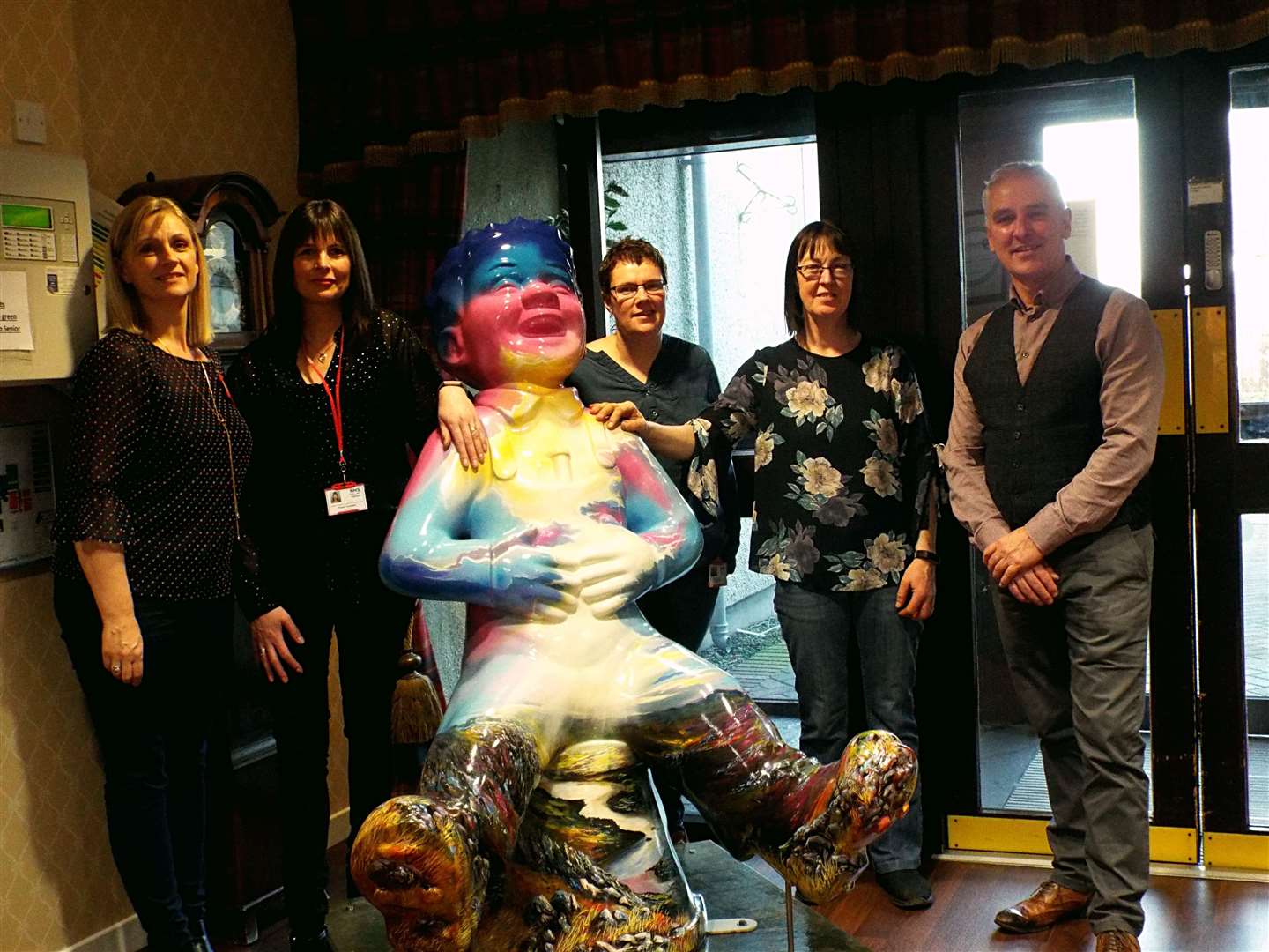 Staff of Pulteney House care home in Wick, along with Councillor Karl Rosie (right), welcome visitor Oor Nevis. Picture: Margaret Fox