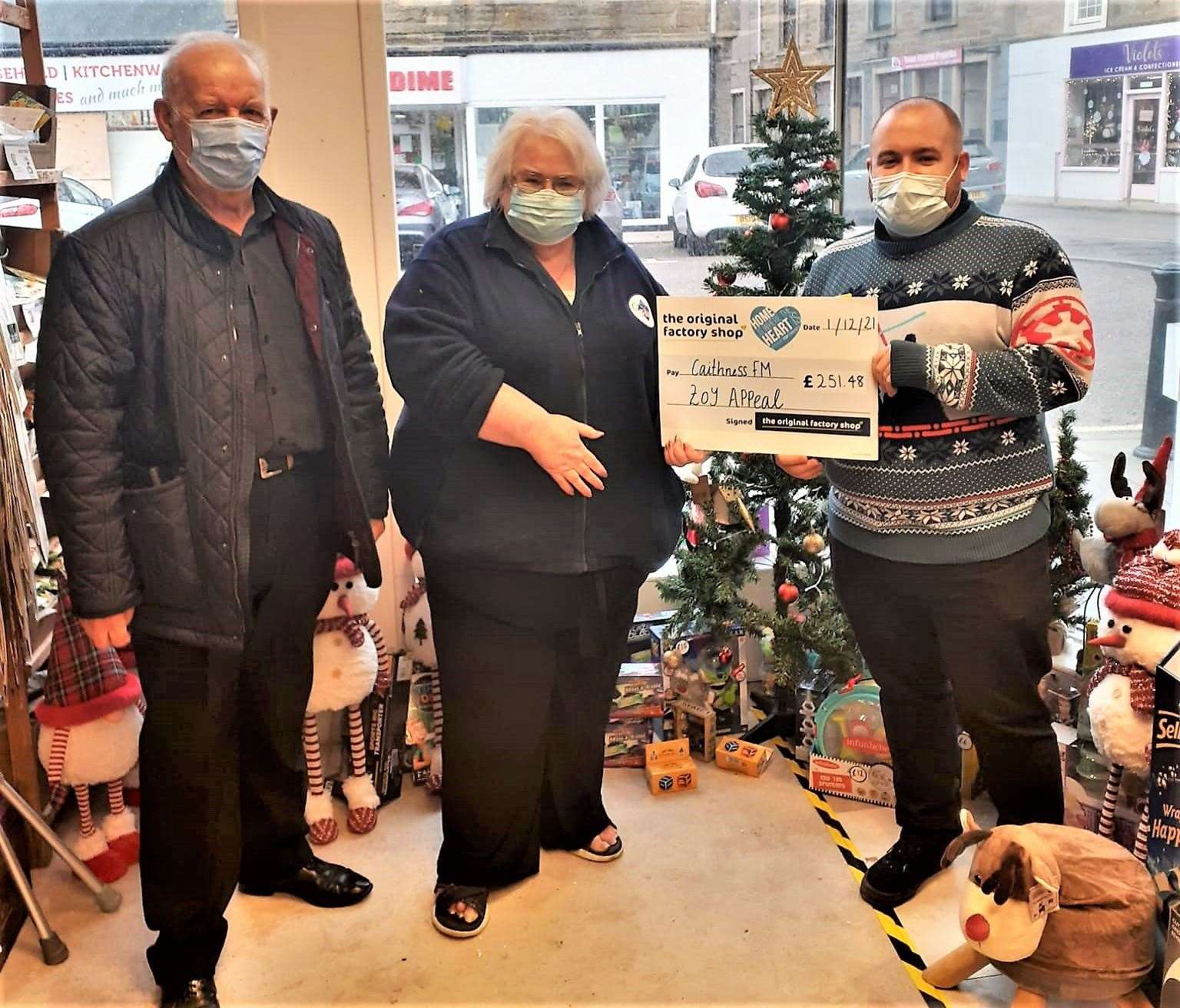 Charity cheque handed over to Caithness FM Toy Appeal. From left, Robin Young and Jackie Johnson from Caithness FM along with Steven Murray, store manager at The Original Factory Shop in Thurso. Picture: TOFS