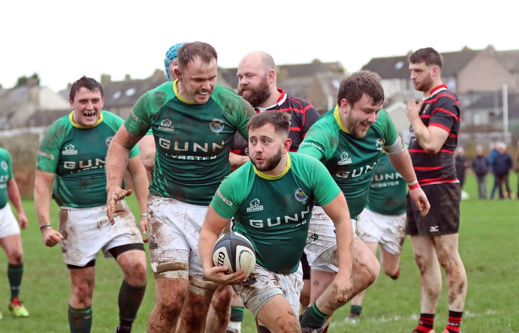 Gordie Macleod (centre) is congratulated after scoring his first try of the afternoon. Picture: James Gunn