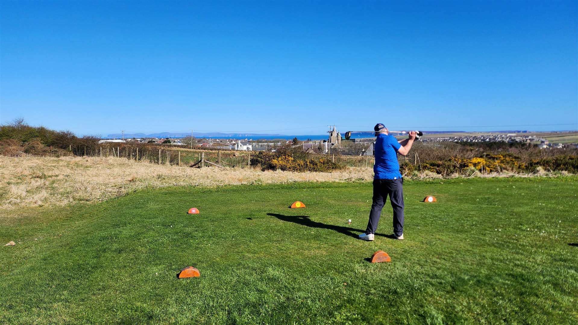 Stephen Osbourne teeing off at Thurso Golf Club.