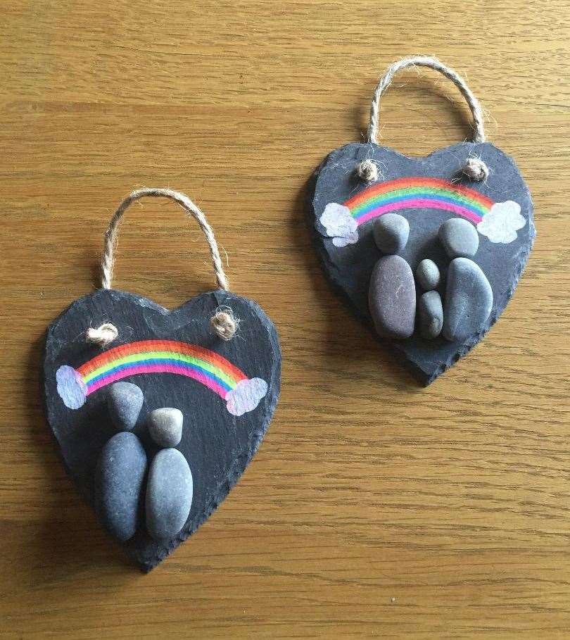 Examples of Zoe's unique rainbows on heart-shaped pieces of slate.