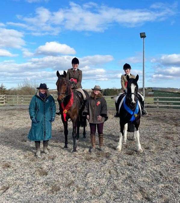 Judges Lara and Kirstin Hourie with the working hunter champion Ruth Sutherland and Saint James, and reserve Mary Miller and Maddie.