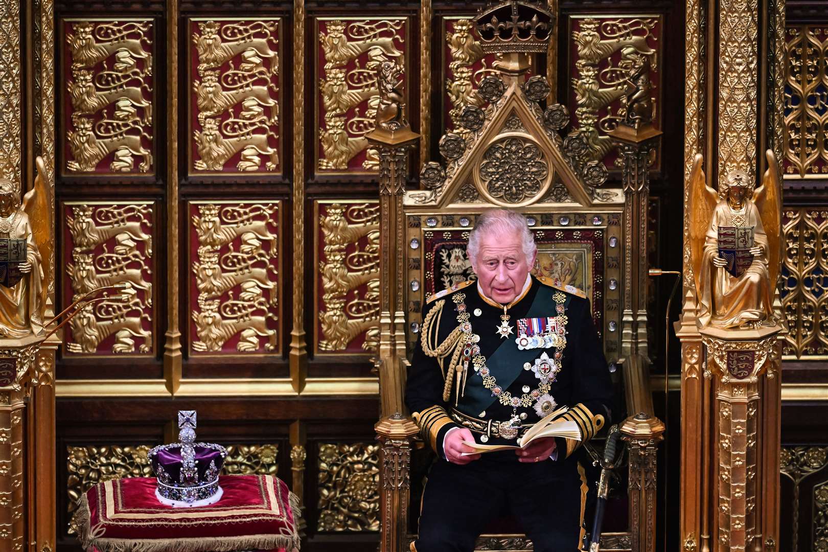 Charles reads the Queen’s Speech as he sits next to the Imperial State Crown during the State Opening of Parliament last year (Ben Stansall/PA)