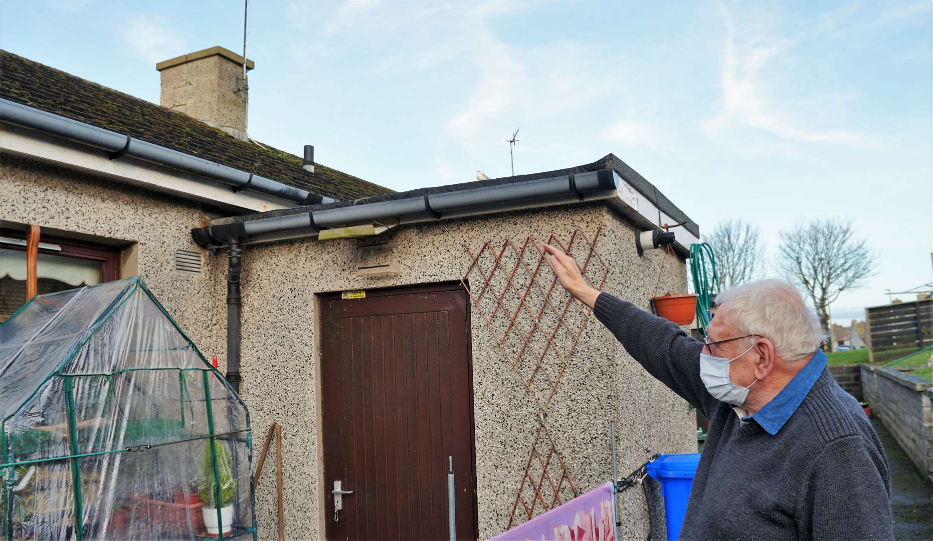 David Lightfoot points to the damaged chimney stack.