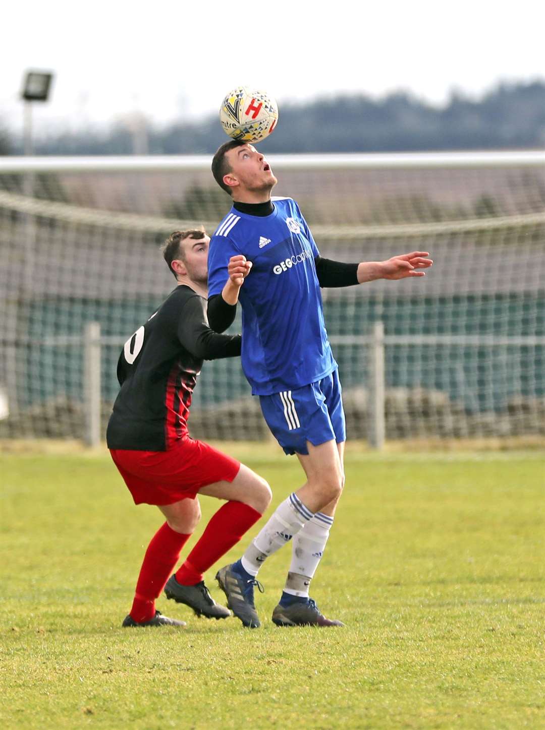 Invergordon's Ken Morrison appears to balance the ball on his head as Colin Henstridge of Halkirk United looks on. Picture: James Gunn