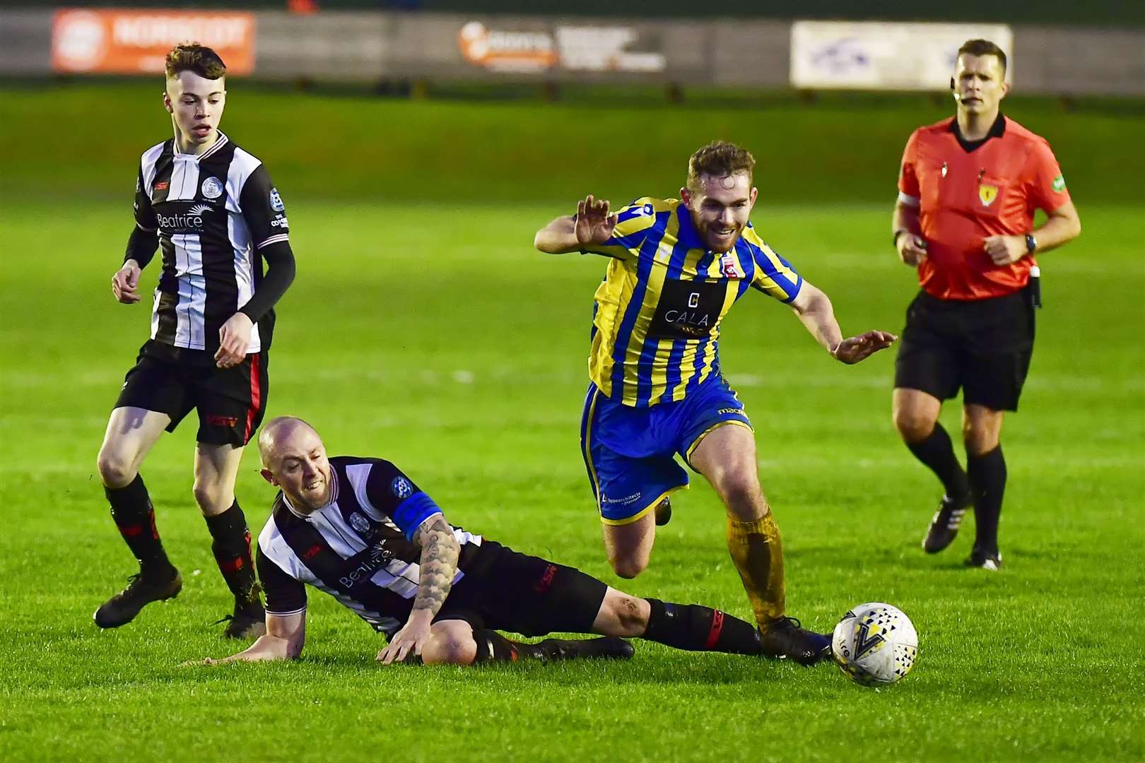Inverurie's Craig Gill goes to ground after a challenge by Wick defender Danny Mackay. Picture: Mel Roger
