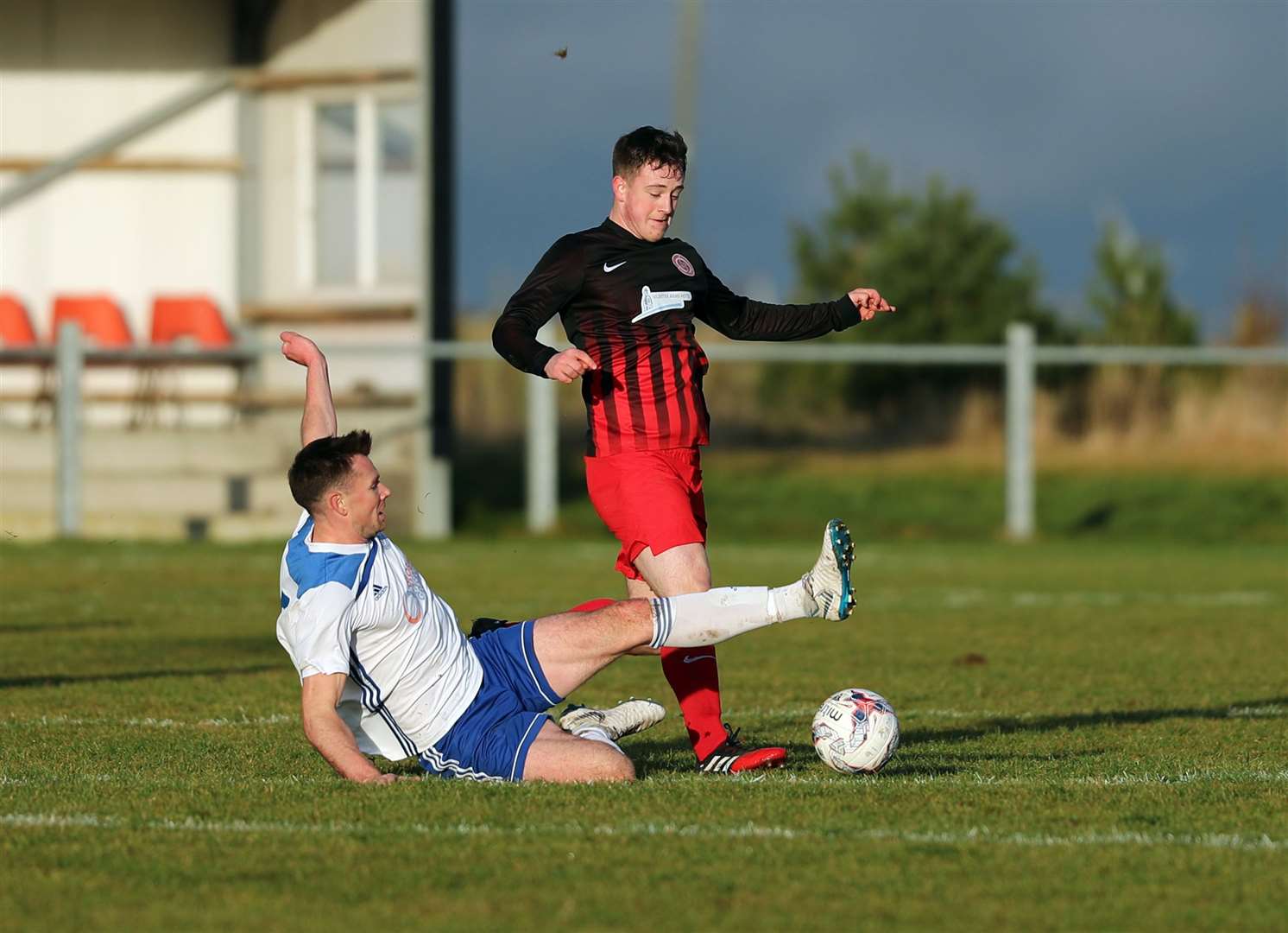 Halkirk United's Steven Sutherland is tackled by Invergrodon's Scott Houston during the Anglers' 4-0 home defeat at the weekend. Picture: James Gunn