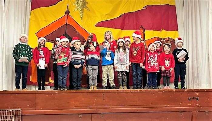 Bower Primary School pupils take to the stage for the Christmas party.