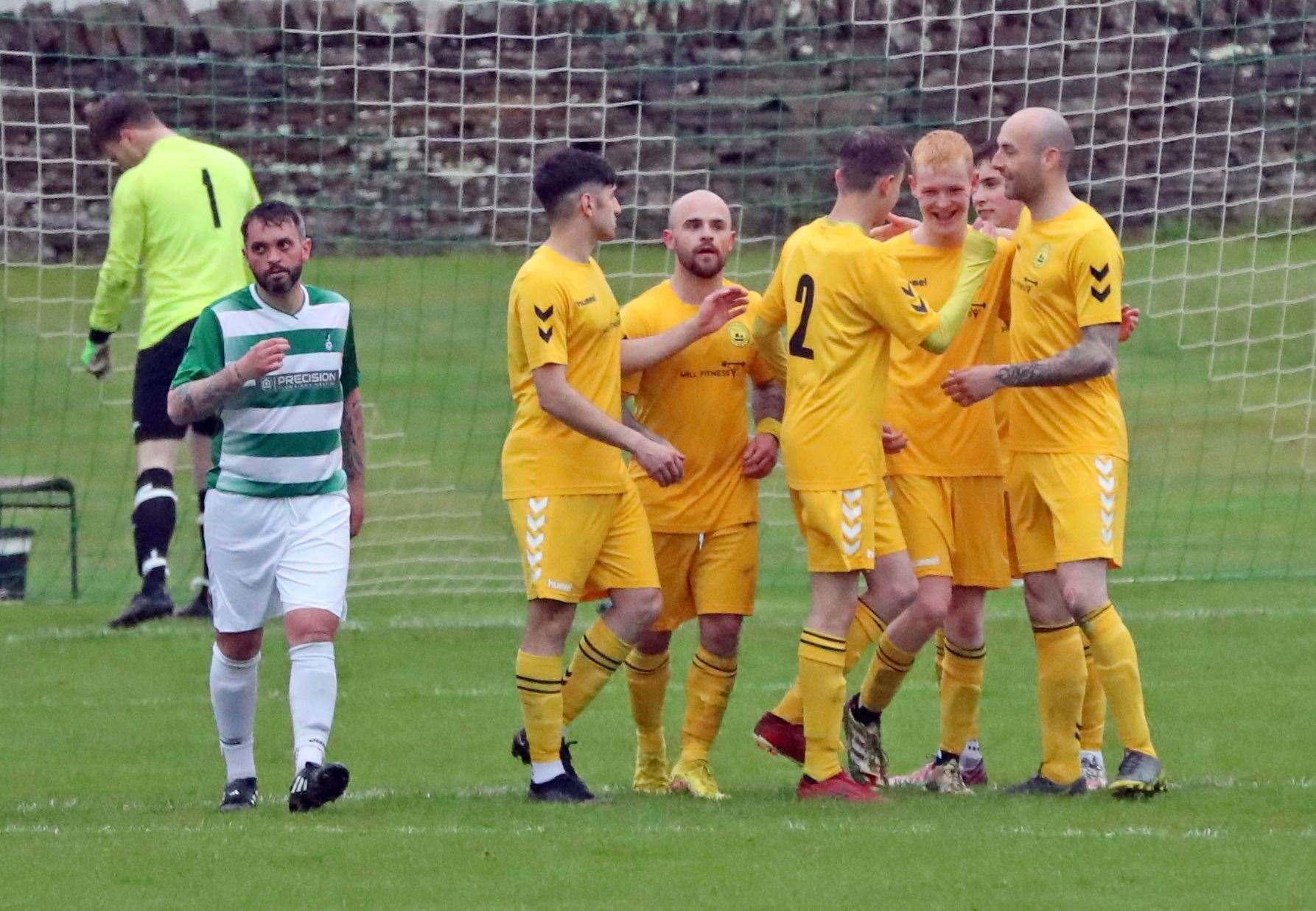 Morgan Kennedy is surrounded by team-mates after his penalty put Staxigoe 2-1 up at Back Park. Picture: James Gunn