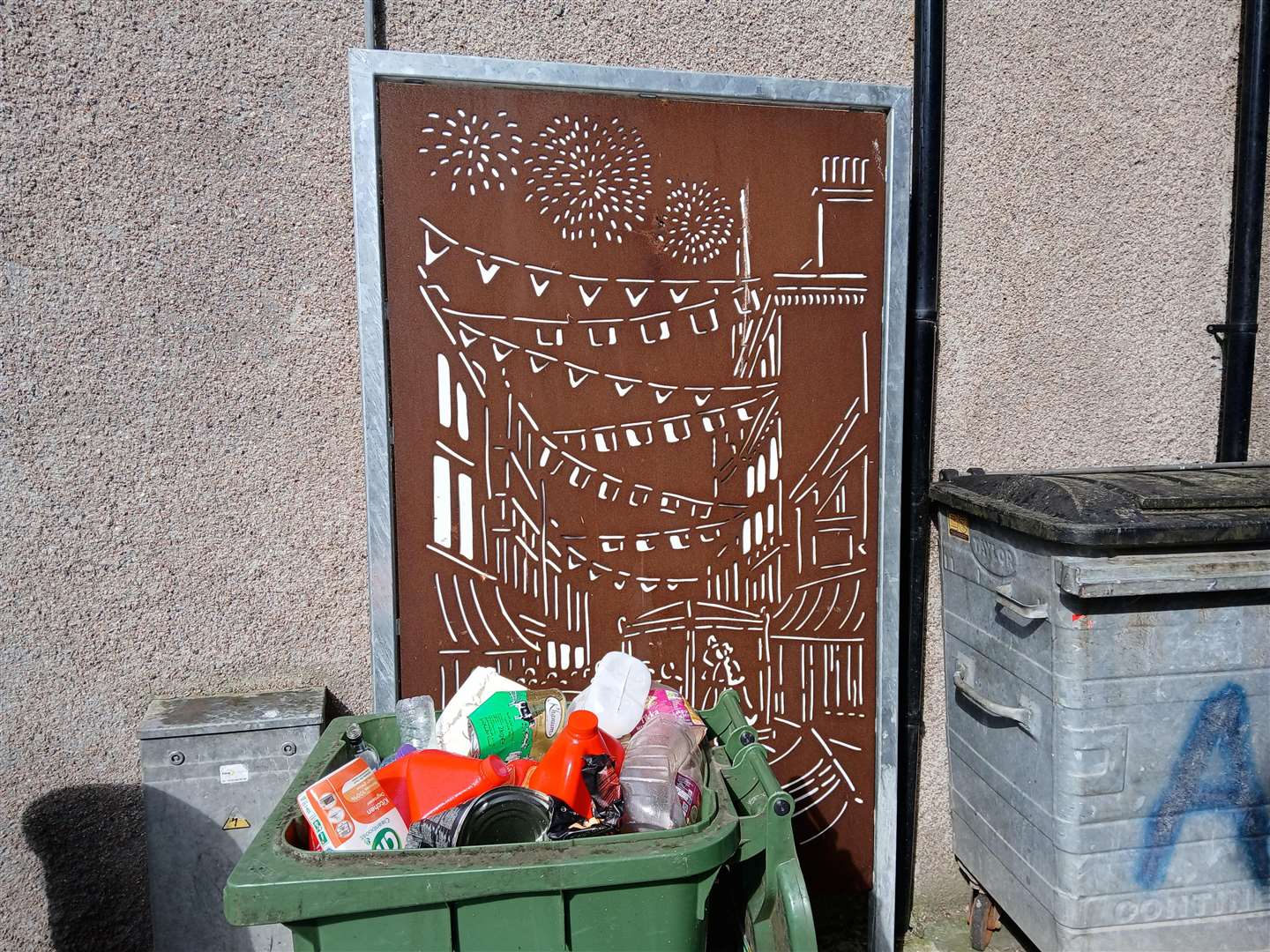 One of the art installations in Wares Lane (Back Bridge Street) has rubbish bins placed in front of it.