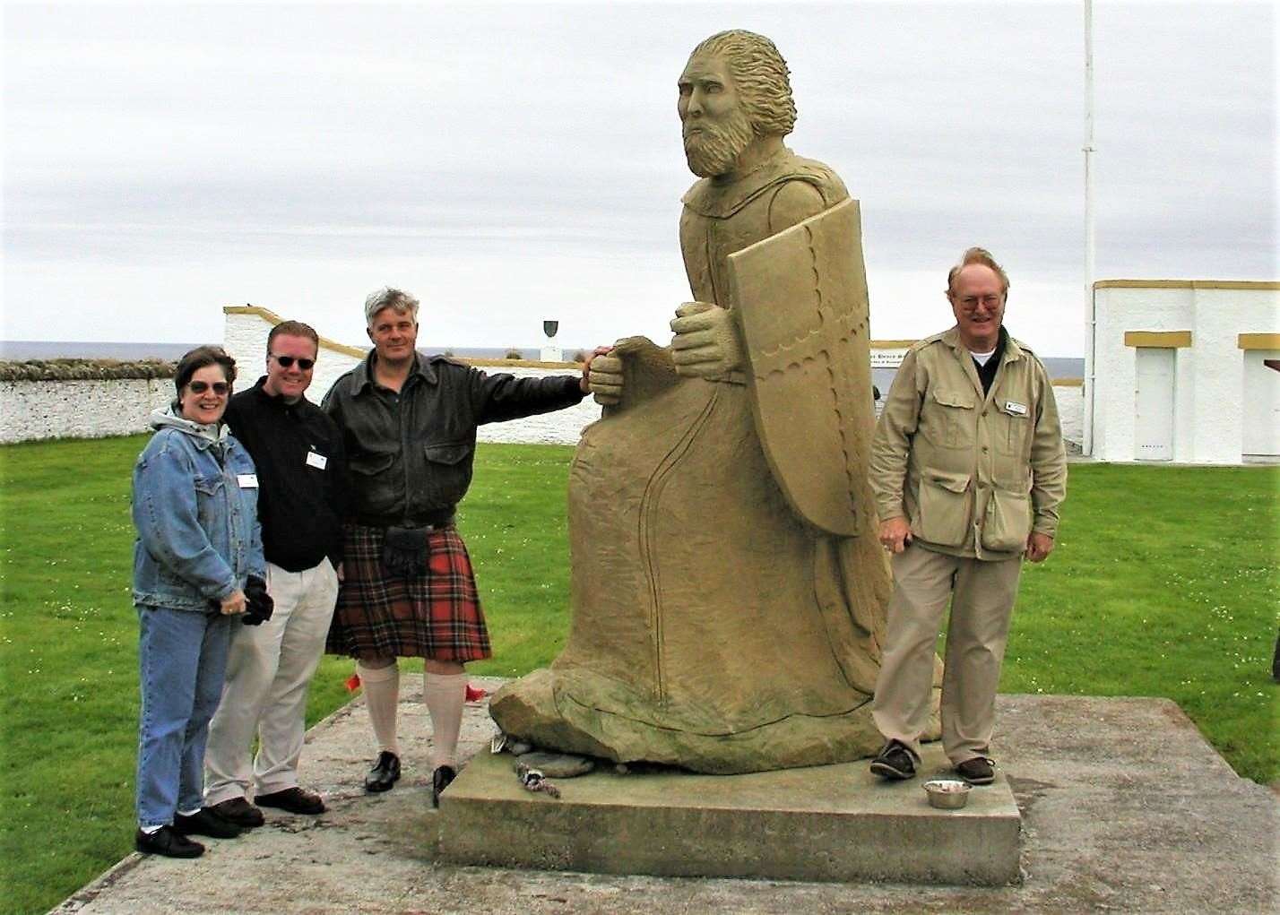 Prince Henry Sinclair statue at Noss Head lighthouse created by Shawn Williamson (wearing kilt). The image was taken around 2005 near the Sinclair Study Centre and with Clan Gunn members.