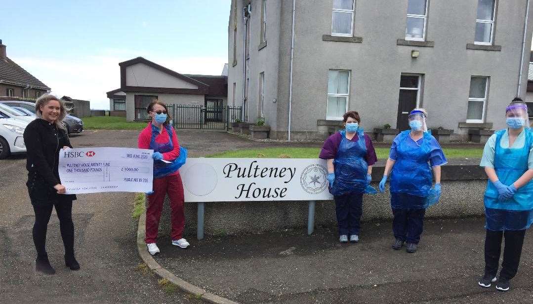 Zoe Sutherland (left) handing over the cheque outside Pulteney House care home.