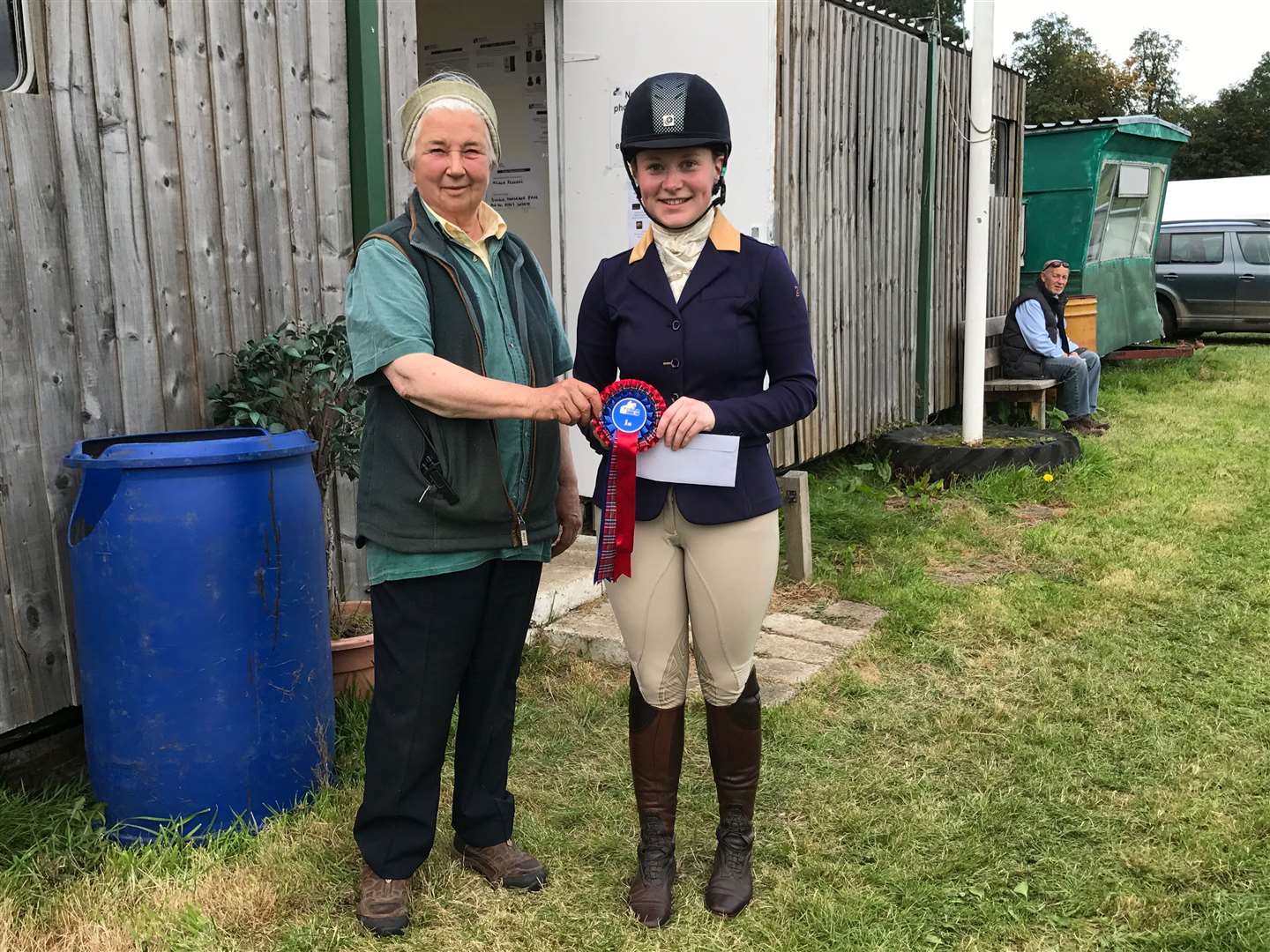 Emma Coghill is presented with her first prize in the novice section at Wee Burgie by Polly Lochore, landowner and course designer.