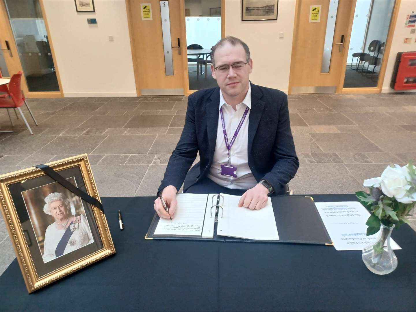 Councillor Andrew Jarvie signing the book of condolence in Caithness House.