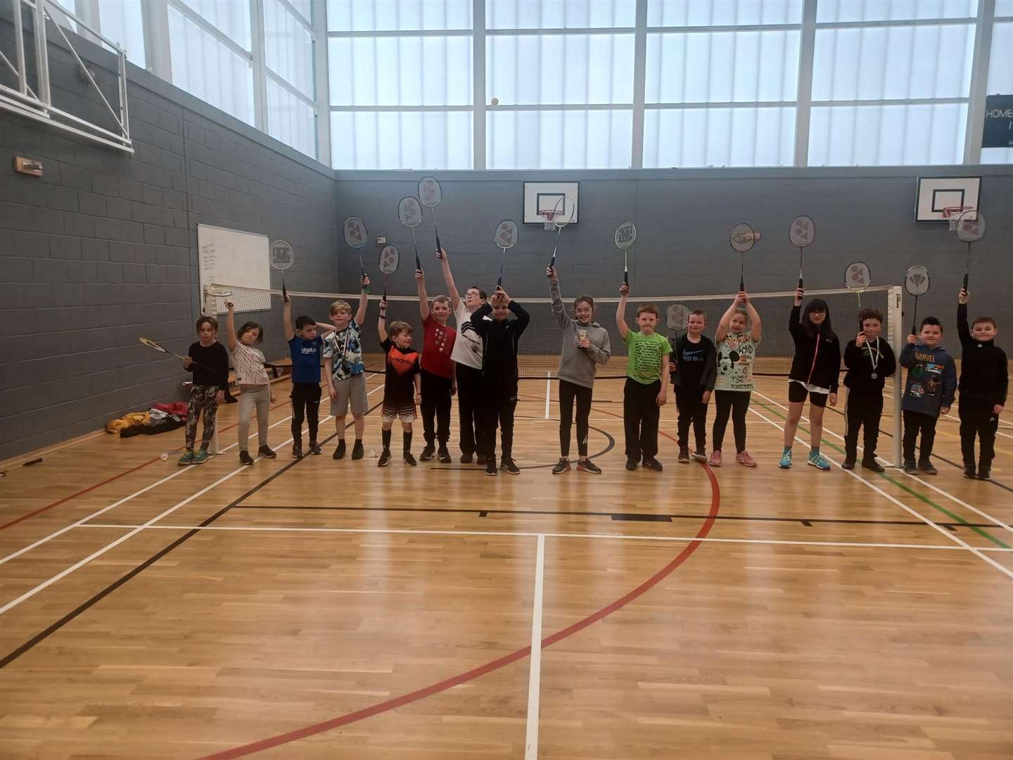 Children raise their racquets at the Wick Active Schools Easter camp.