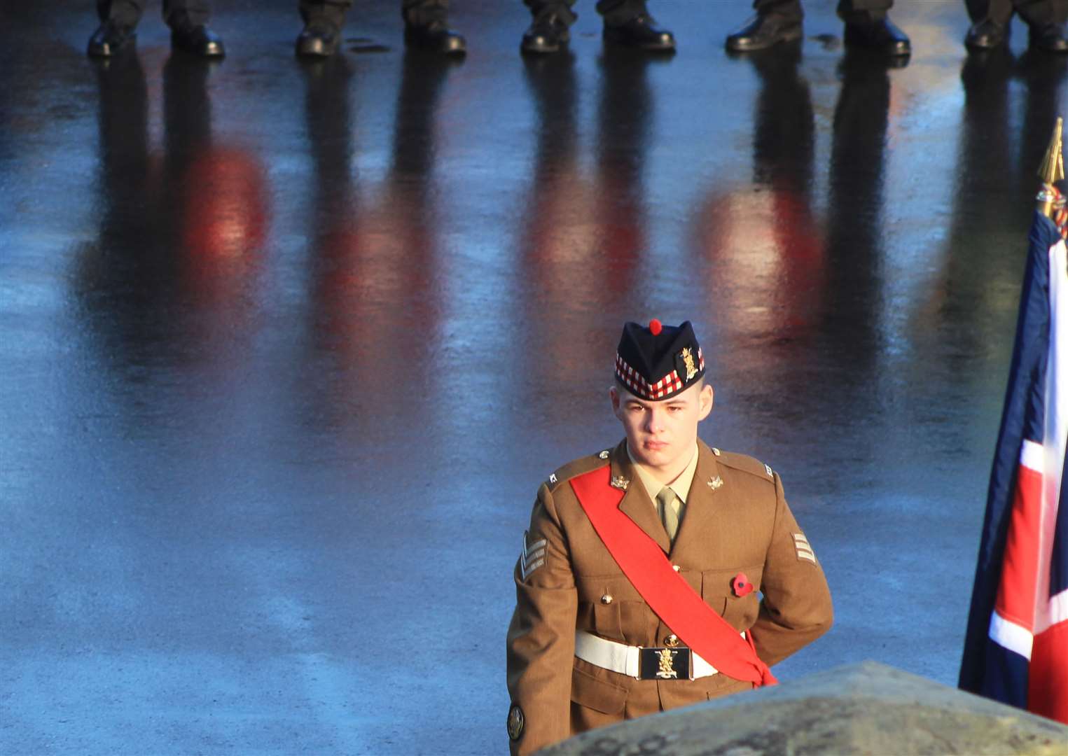 A young soldier with reflections of poppy wreaths in the background. Picture: Alan Hendry