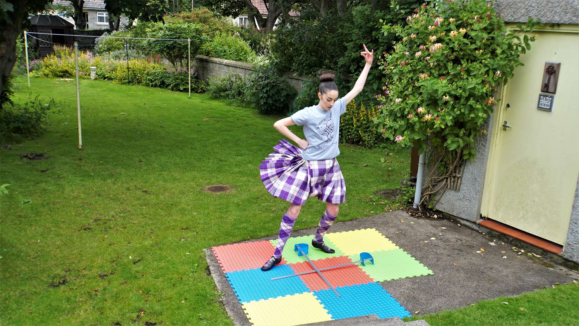 Florence dances the sword at her garden on West Banks Avenue. Picture: DGS