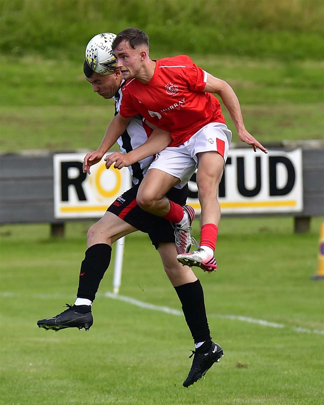 Wick Academy's Ryan Campbell and Nairn County's Sam Gordon go for a high ball. Picture: Mel Roger