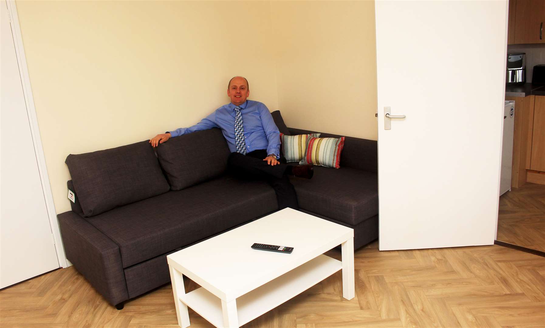 Andrew Mackay sitting in one of the newly refurbished apartments. Picture: Alan Hendry
