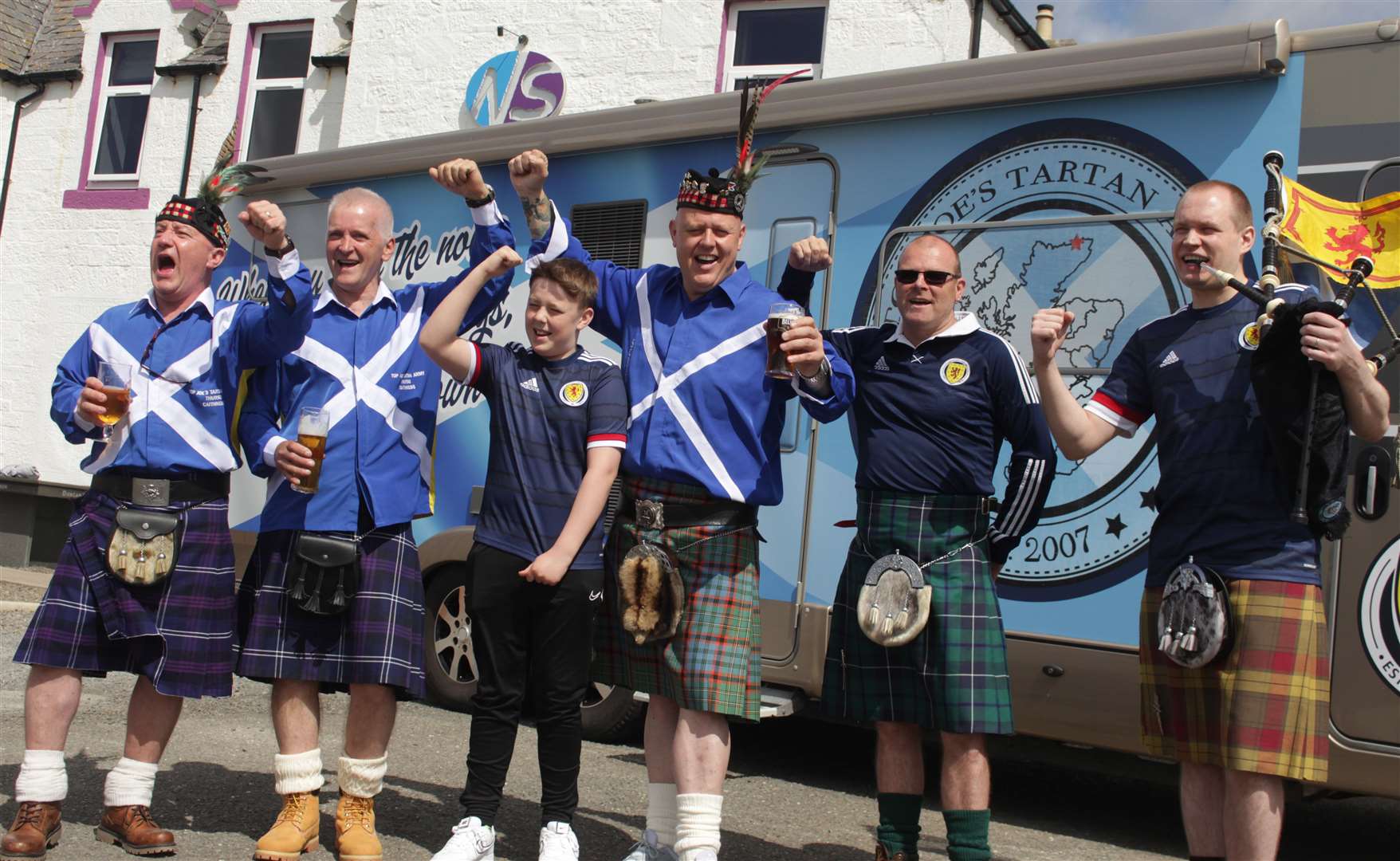 Members of Top Joe's Tartan Army before setting off from the Northern Sands Hotel on Sunday morning. Martin Nicolson's son Logan (12) was among those cheering on the supporters. Picture: Alan Hendry
