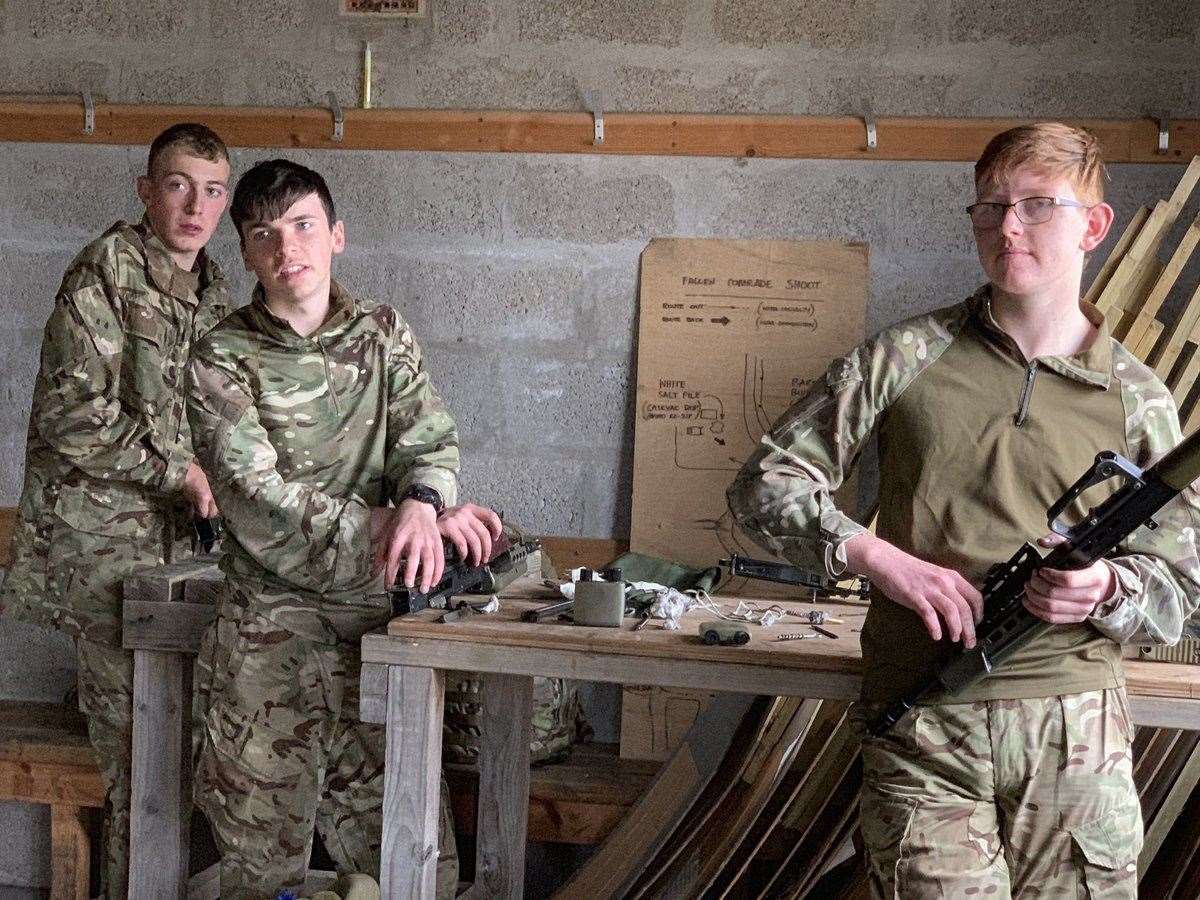 RSM Jack (second left) and Sgt Sutherland-West (right) enjoying the perks of winning the shooting – having to clean their weapons afterwards.