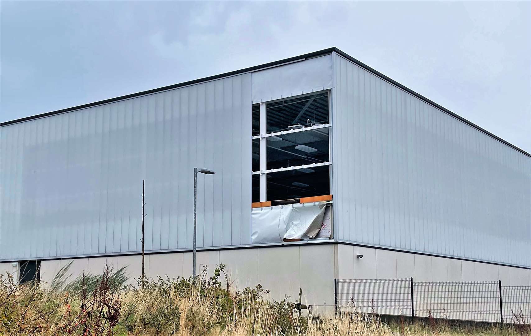 A panel from the side of Wick High School's gym was ripped off during the storm this morning.