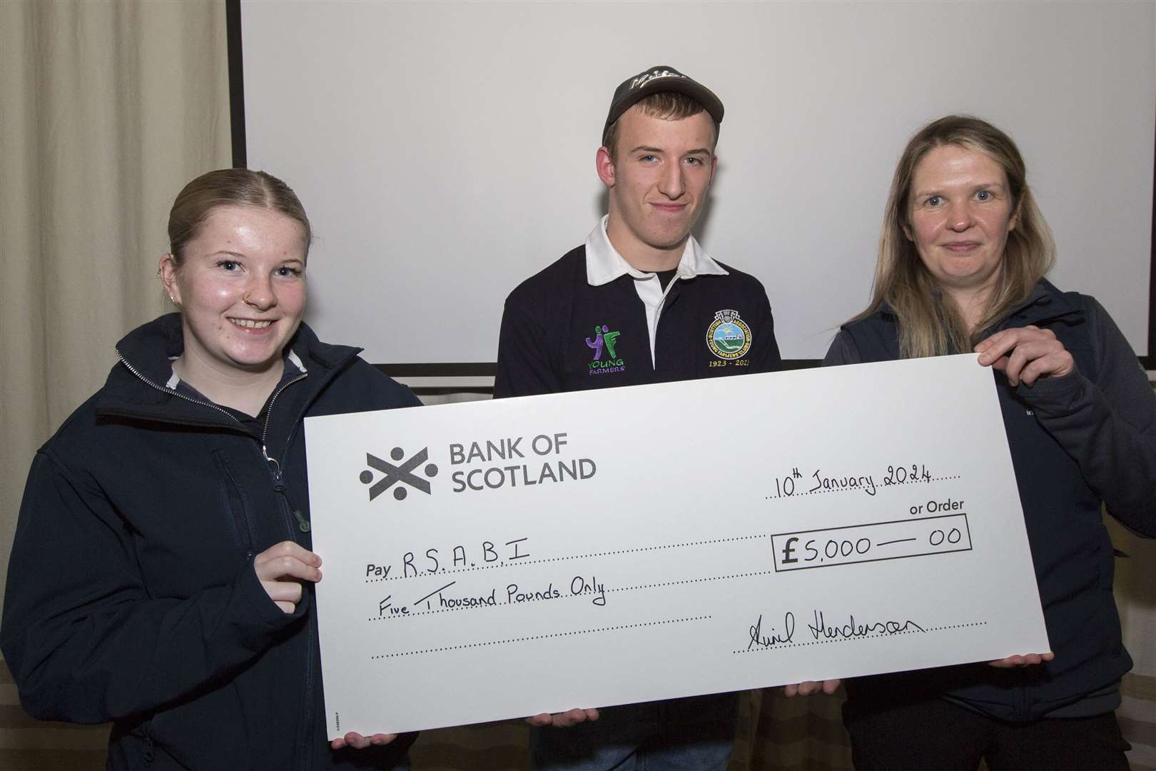 Faye Mackay (left), of Forss Young Farmers, and Tyler Gordon, Halkirk, present a £5000 cheque to Shirley Hastings, RSABI case officer for the Highlands and Islands. Picture: Robert MacDonald / Northern Studios