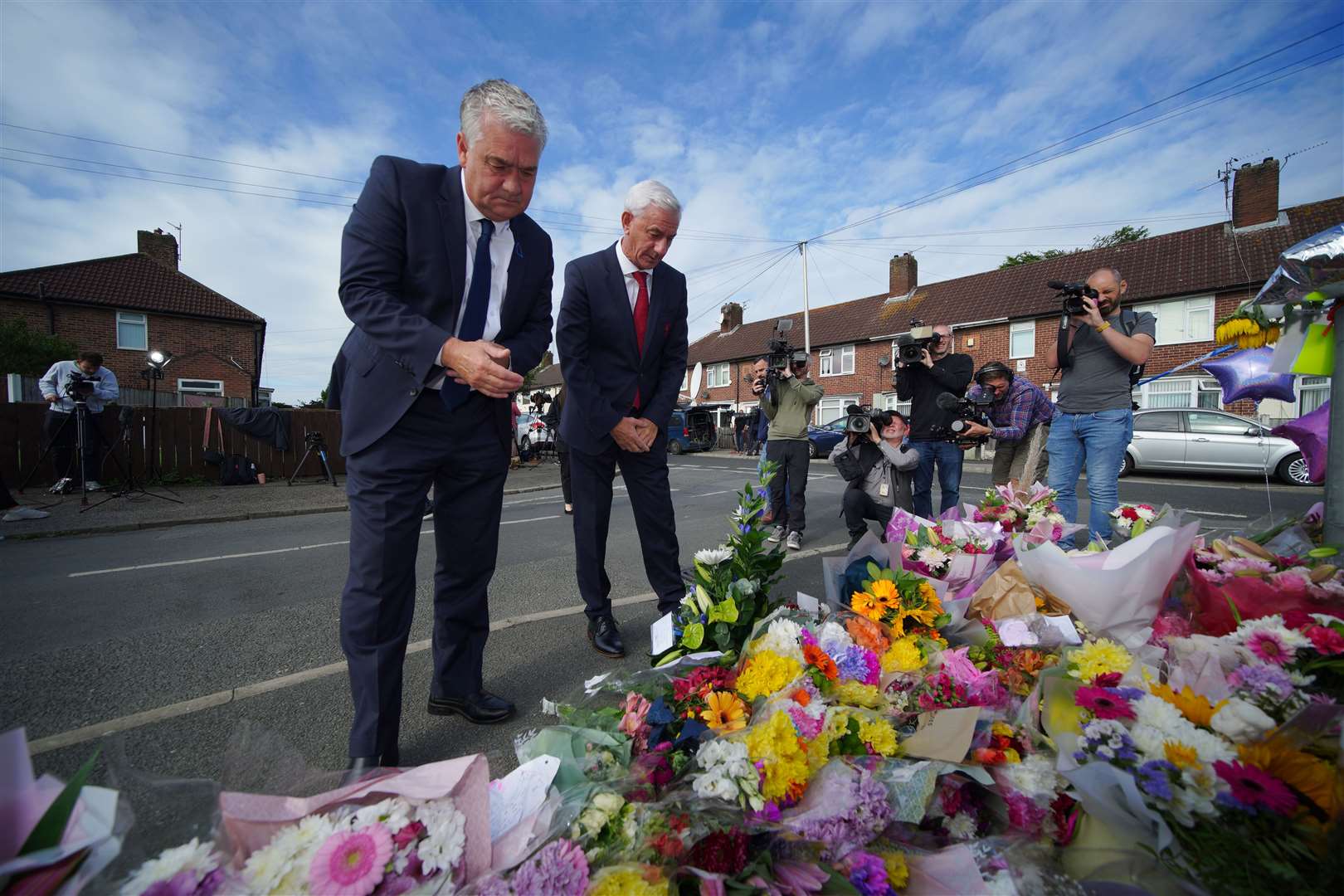 Ambassador of Liverpool FC, Ian Rush (right), and the ambassador of Everton FC, Ian Snodin, visit the scene in Kingsheath Avenue (Peter Byrne/PA)