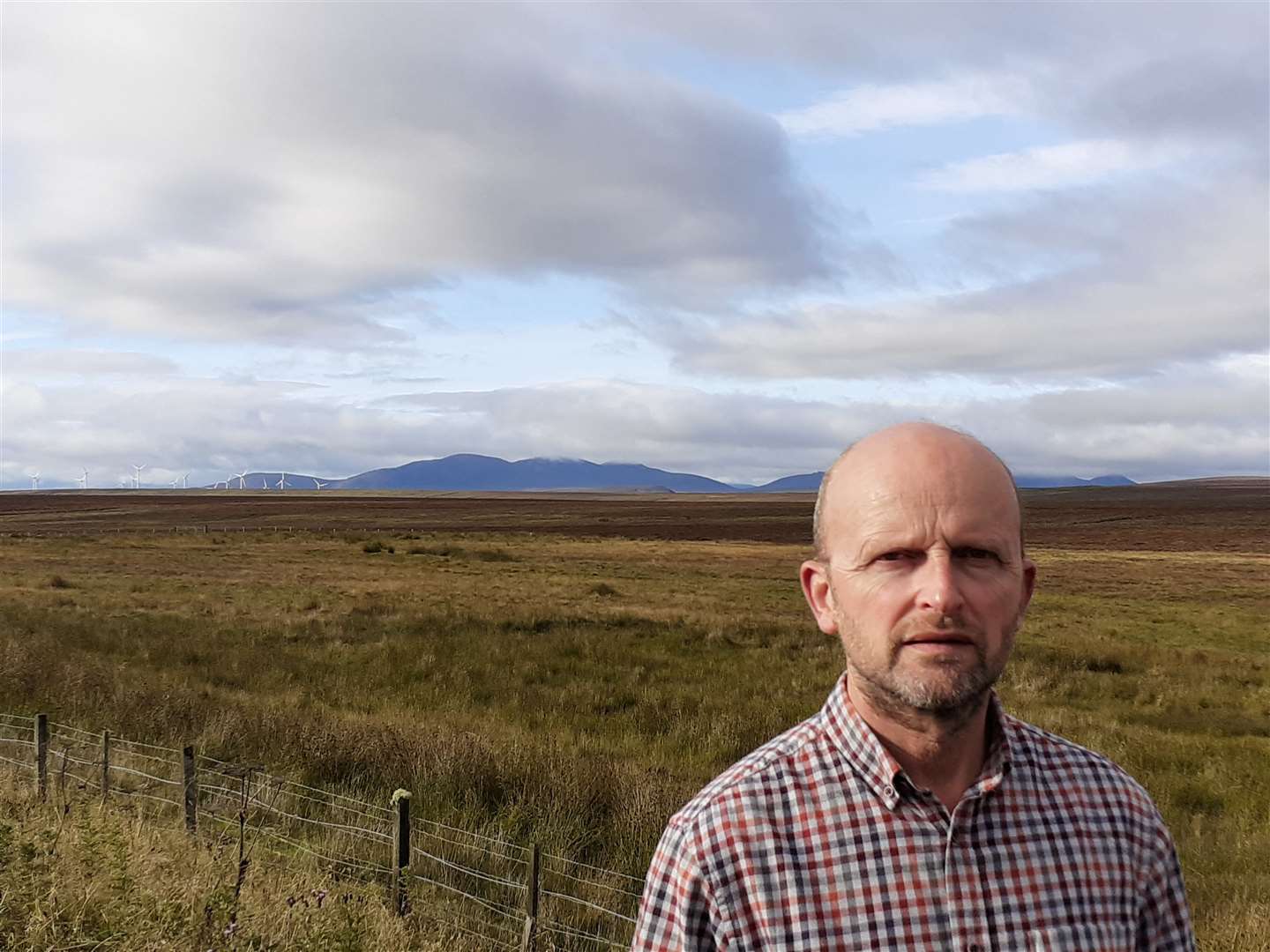 Councillor Matthew Reiss near one of the county's existing wind farms. Picture: Alison Reiss