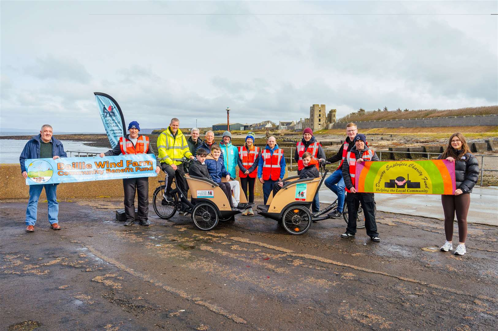 Kevin Oag (yellow jacket), captain of the new Thurso chapter of Cycling Without Age, and his Wick counterpart George Ewing (standing, fifth from left) along with volunteers and representatives of funding bodies. Picture: Stevie Bruce