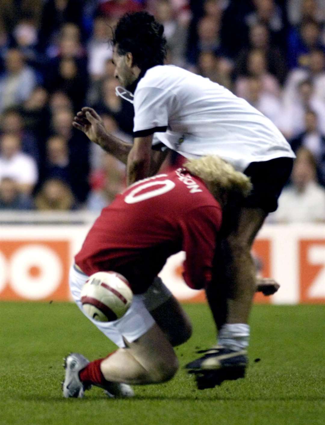 Mr Johnson forces a rugby tackle on German footballer Maurizio Gaudino during a legends match in Reading in 2006 (Rebecca Naden/PA)