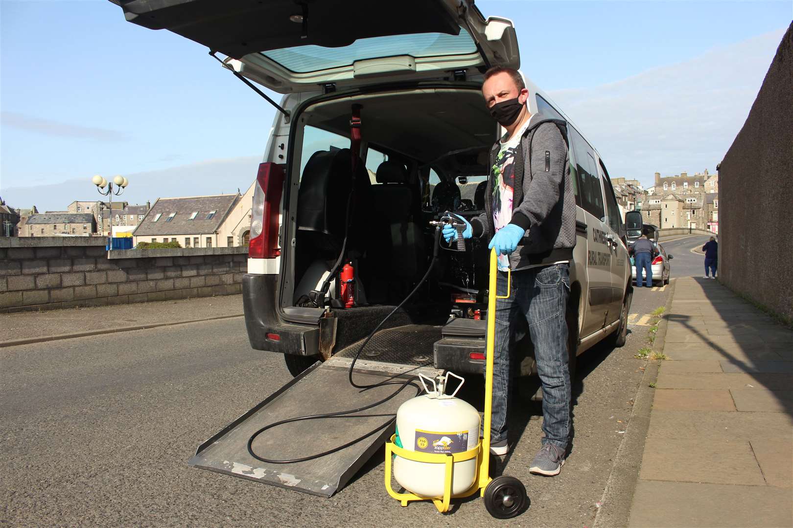Caithness Rural Transport driver Andrew Sutherland demonstrating a Zapptizer device which allows disinfecting sanitiser to be applied to vehicles via a spray mechanism.