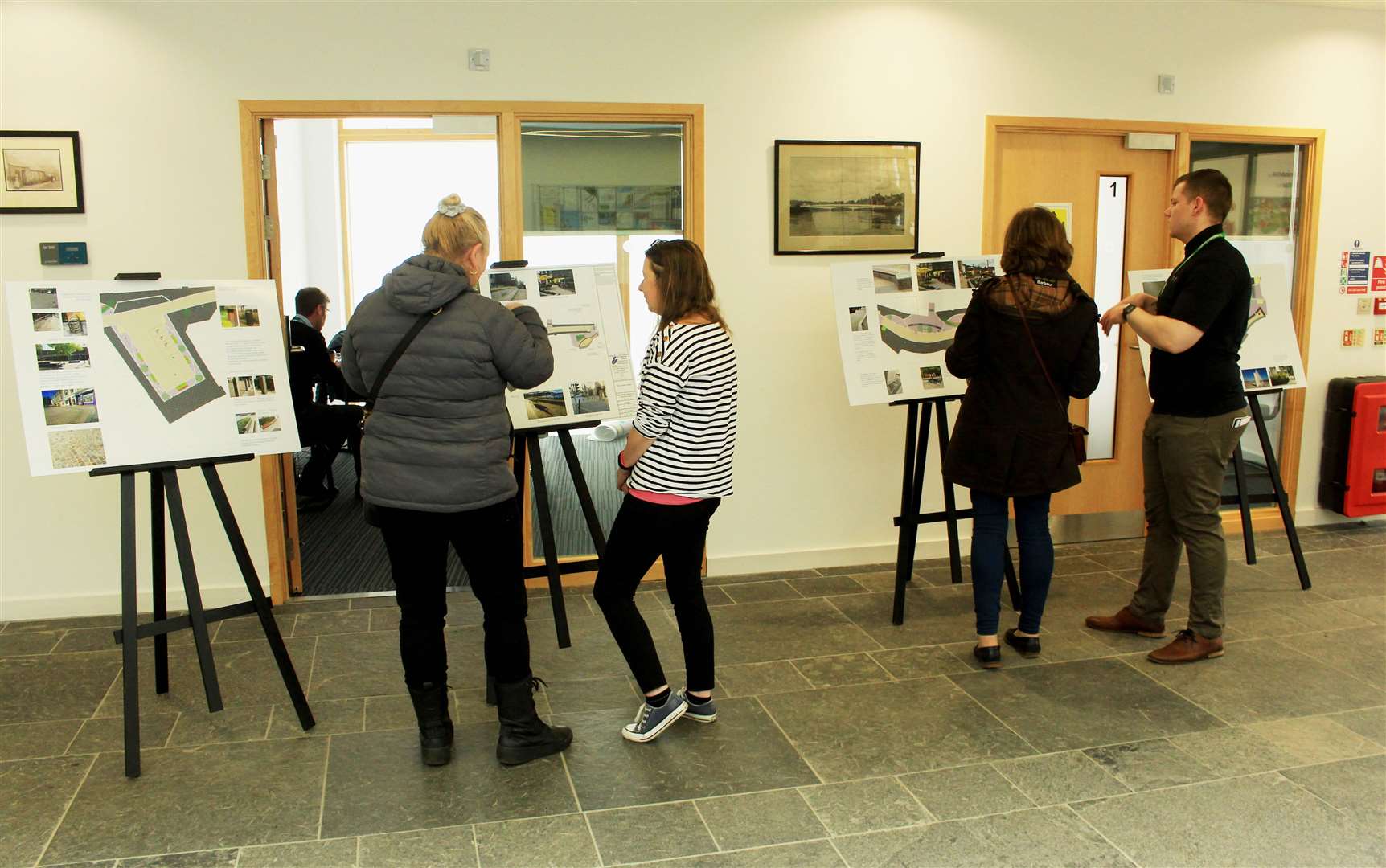 Carolyn Smith and Adam Manson from the Highland Council team discussing the town centre designs with members of the public on Friday.