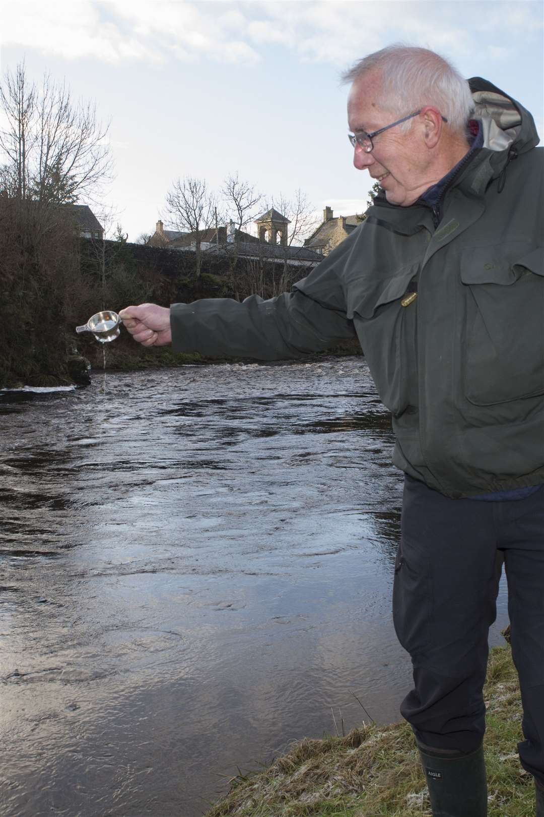 Alan Youngson, Caithness District Salmon Fishery Board's scientific adviser, toasting the River Thurso on the opening day of the 2022 season. Picture: Robert MacDonald / Northern Studios