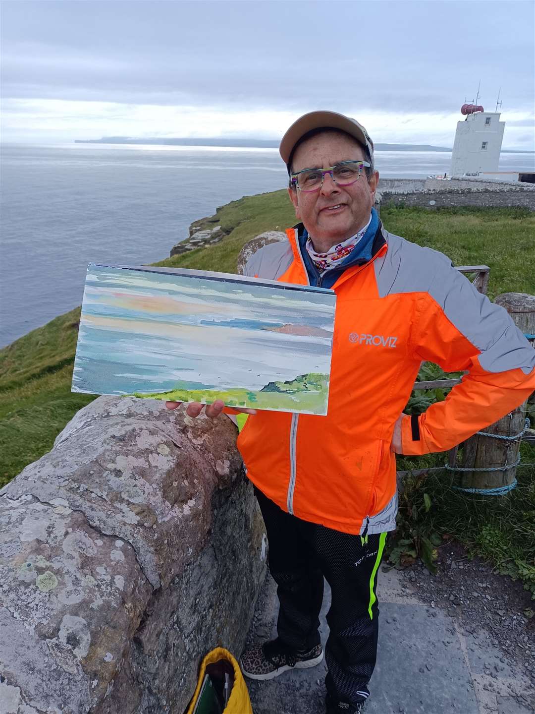 Timmy with one of his watercolours at Dunnet Head.