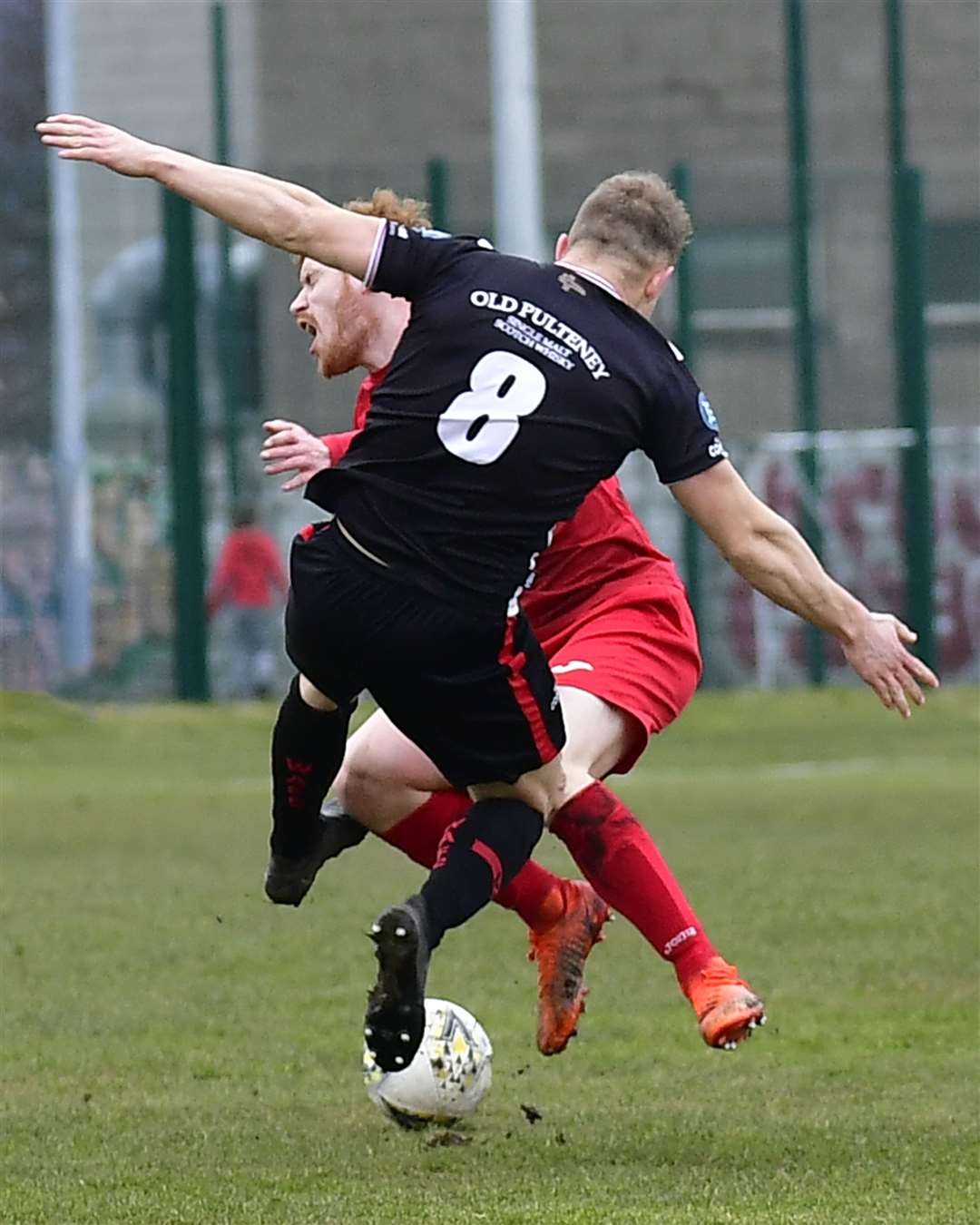 Brora goal hero Greg Morrison is brought down by Wick's Jack Halliday, who was shown the red card. Picture: Mel Roger