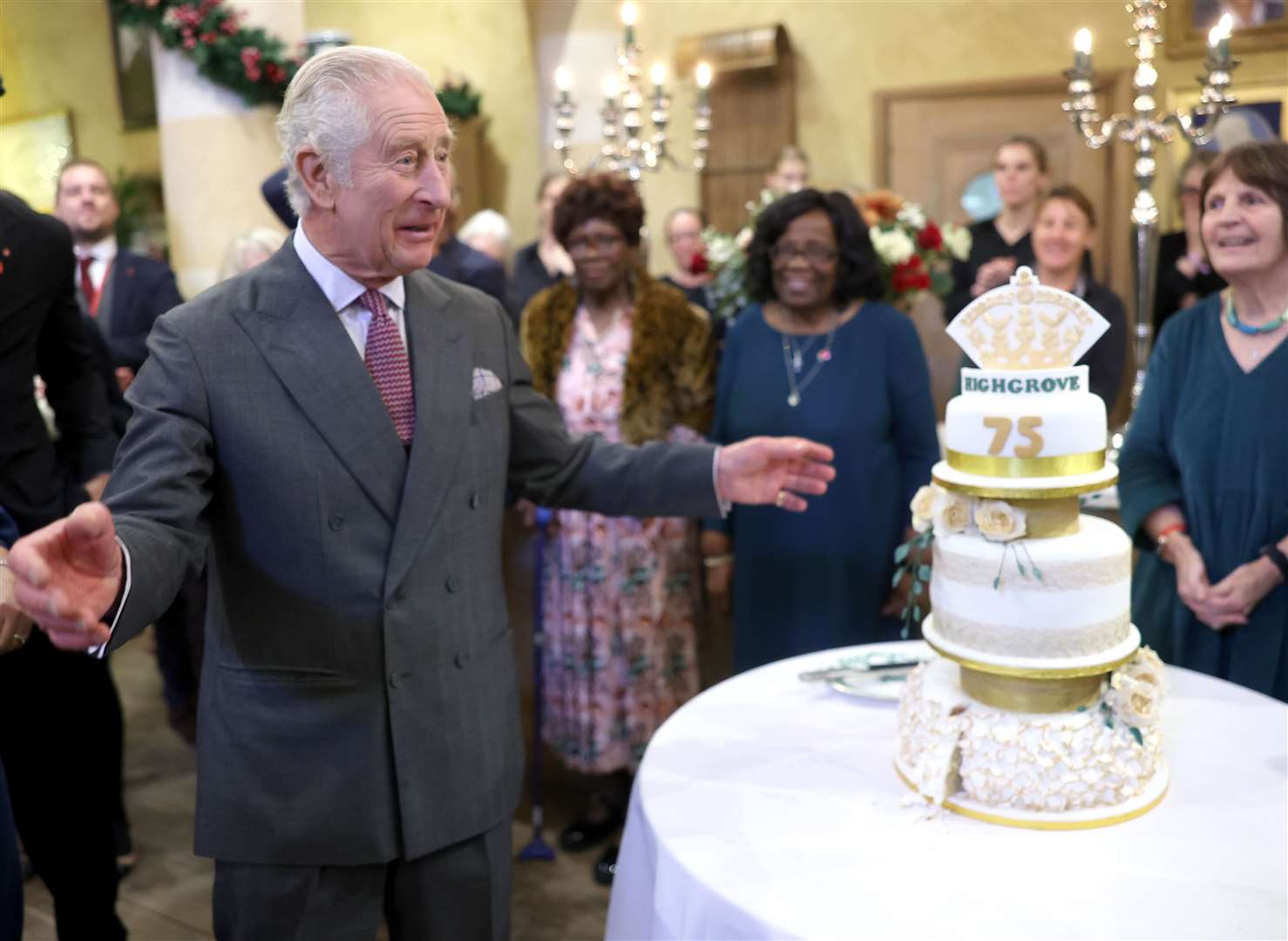The King with a birthday cake during his 75th birthday party at Highgrove Gardens in Tetbury on the eve of his birthday in November, with community champions who were also celebrating turning 75 in 2023 (Chris Jackson/PA)