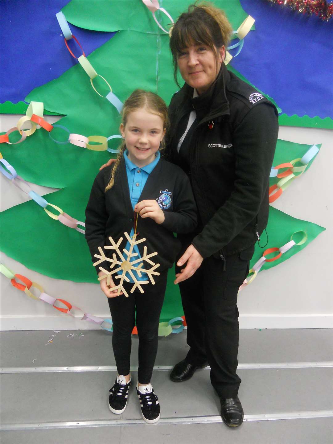 Zara MacKintosh, the winner of the Christmas decoration from recycled materials competition, with judge Christine Lord, of the SSPCA.