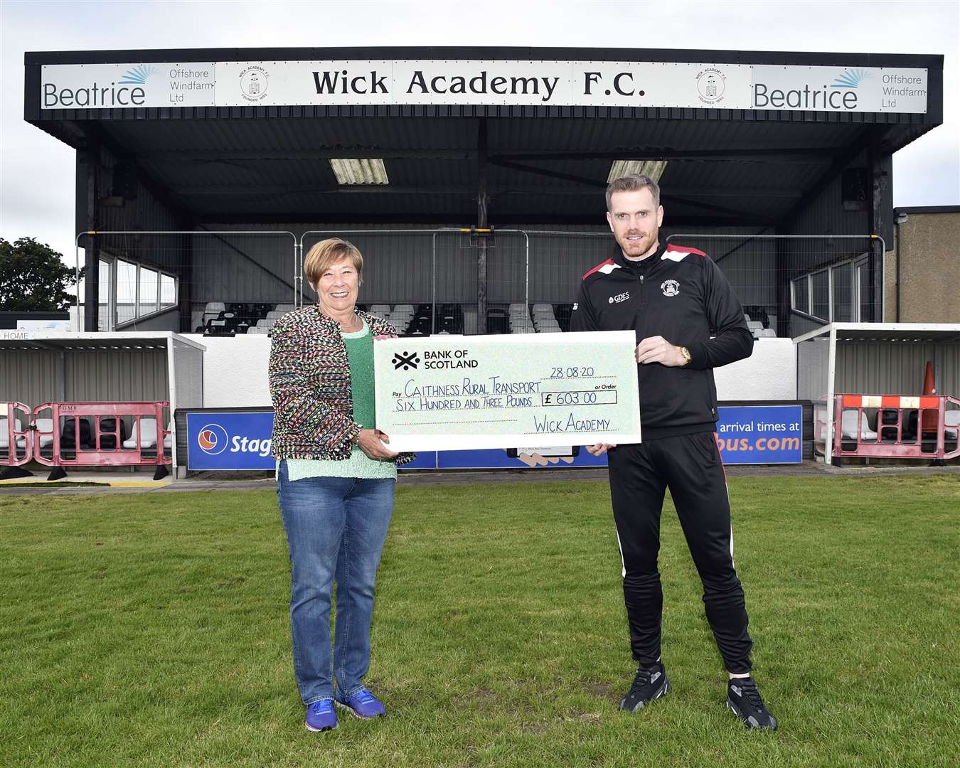 Caithness Rural Transport co-ordinator Coreen Campbell receives the £603 cheque from Wick Academy's Craig Gunn. Picture: Mel Roger