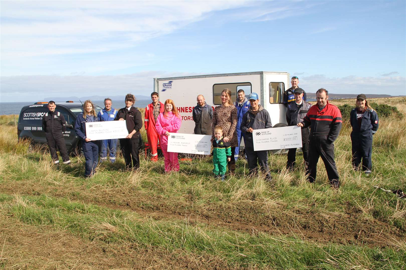 Cheques for £500 were presented by junior drivers to three local groups at the sixth autocross of the season. In the front row Nicola Donn (left), can be seen presenting a cheque to Christine Lord, of the Scottish SPCA Rescue & Rehoming centre Balmore, while Immy Durrand hands over £500 to Jacqueline Keith and young George Coghill of Halkirk Playgroup, and Ryan Henderson presents the cheque to club chairman Lenny Humphries for Caithness Klics young carers. Looking on are several drivers and mechanics. Picture: Willie Mackay