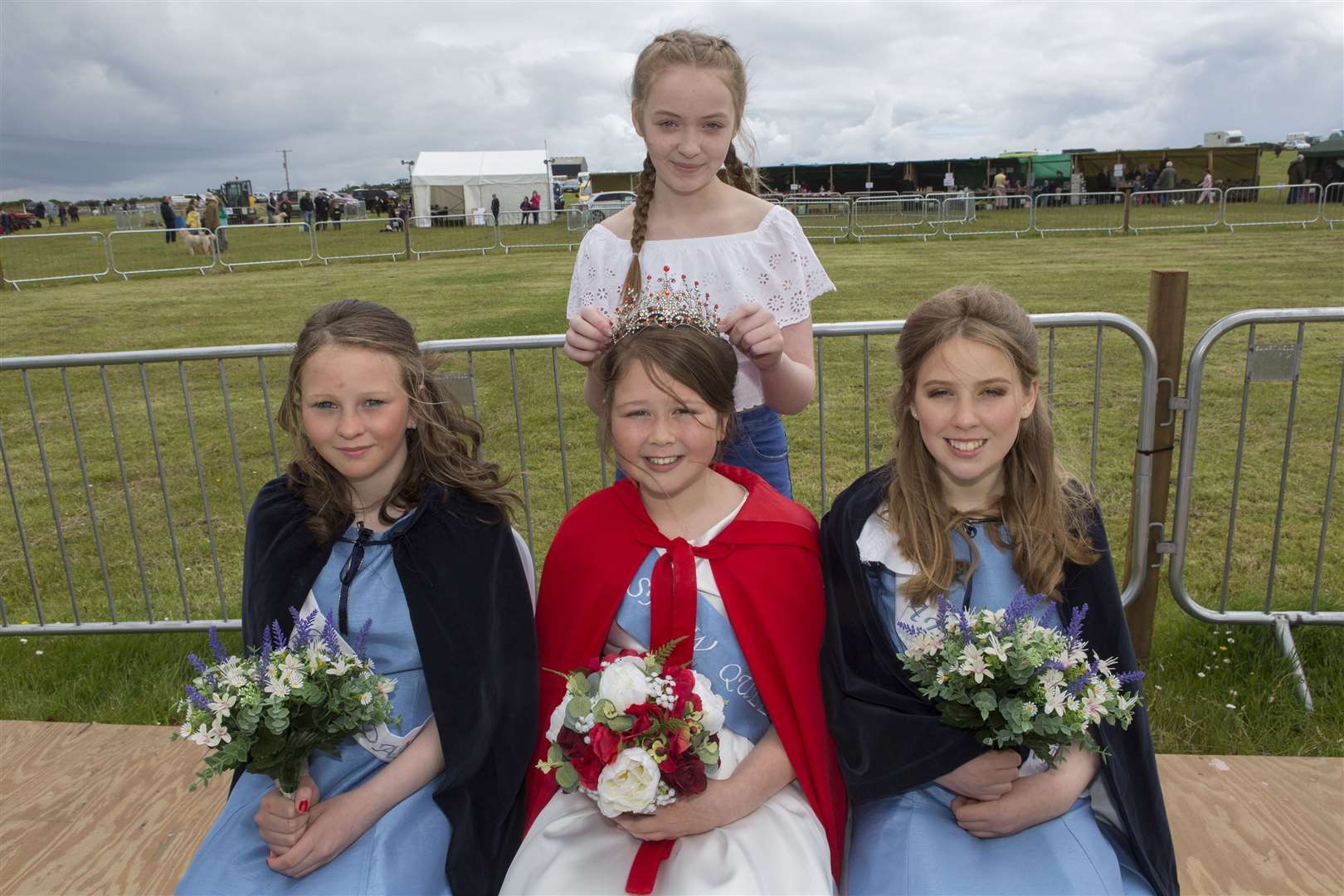 Show queen Heidi Newman is crowned by retiring queen Emma Simpson. Looking on are attendants Dakota Skene (left) and Mairi Hillhouse. Picture: Robert MacDonald / Northern Studios